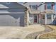 Shows the front of a gray home featuring a 2-car garage, and stone accents at 11042 Blackwolf Ln, Parker, CO 80138