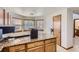Charming eat-in kitchen with granite countertops, wood cabinets, and natural light from bay windows at 11042 Blackwolf Ln, Parker, CO 80138