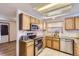 A beautiful kitchen featuring stainless steel appliances, granite countertops, and wood cabinets at 11042 Blackwolf Ln, Parker, CO 80138