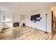 Spacious living room with hardwood floors, fireplace and large tv mounted to the wall at 11042 Blackwolf Ln, Parker, CO 80138
