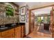 Stylish bar area leading to an office with wood floors and ample natural light at 10227 Osceola Ct, Westminster, CO 80031