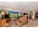 Finished basement with a TV, couches and lounge area, and a small bar area at 10227 Osceola Ct, Westminster, CO 80031
