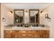 Bathroom with a dual sink vanity, framed mirrors, and neutral countertops at 10227 Osceola Ct, Westminster, CO 80031