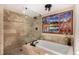 Relaxing bathroom with a soaking tub, walk-in shower, and scenic views at 10227 Osceola Ct, Westminster, CO 80031