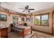 Bedroom features a ceiling fan, a large window, and built-in shelves for storage at 10227 Osceola Ct, Westminster, CO 80031