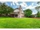 Back of house showing manicured lawn and multi-level deck, and patio at 10227 Osceola Ct, Westminster, CO 80031