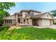 Suburban home boasts a well-manicured lawn, front porch, and three car garage at 10227 Osceola Ct, Westminster, CO 80031