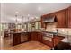 Spacious kitchen with stainless steel appliances, custom cabinets, and hardwood floors at 10227 Osceola Ct, Westminster, CO 80031