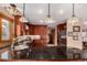 Well-lit kitchen boasting dark wood cabinetry, granite countertops, and stainless steel appliances at 10227 Osceola Ct, Westminster, CO 80031
