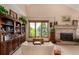 Bright living room with vaulted ceilings, a brick fireplace, and custom built in bookcase at 10227 Osceola Ct, Westminster, CO 80031
