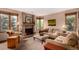 Cozy living room features a brick fireplace and large windows with natural light at 10227 Osceola Ct, Westminster, CO 80031