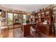 An office with hardwood floors, custom shelving, and a large window at 10227 Osceola Ct, Westminster, CO 80031