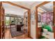 View of a well-lit home office with hardwood floors, large wooden desk, and view to the bathroom at 10227 Osceola Ct, Westminster, CO 80031