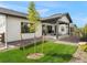 Landscaped backyard with a covered patio, offering an ideal space for outdoor living at 5492 Woodroot Pt, Castle Rock, CO 80104