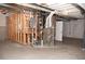 Unfinished basement with water heater, modern furnace, and painted cement floor at 5492 Woodroot Pt, Castle Rock, CO 80104