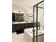 Luxurious bathroom featuring a double vanity, walk-in shower, and marble tile at 5492 Woodroot Pt, Castle Rock, CO 80104