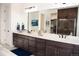 Bathroom with a double vanity, undermount sinks, and a stand-alone shower at 5492 Woodroot Pt, Castle Rock, CO 80104