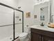 Bright bathroom featuring a glass enclosed shower, modern vanity, and stylish decor at 5492 Woodroot Pt, Castle Rock, CO 80104