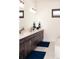 Bathroom with a double vanity, marble countertops, and modern fixtures at 5492 Woodroot Pt, Castle Rock, CO 80104