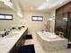 Bathroom features a double vanity, large soaking tub, and a glass shower at 5492 Woodroot Pt, Castle Rock, CO 80104