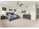 Well-lit bedroom with a large bed, dresser, and contemporary decorations at 5492 Woodroot Pt, Castle Rock, CO 80104