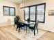 Modern dining room with stylish lighting and window shutters at 5492 Woodroot Pt, Castle Rock, CO 80104