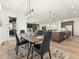 Dining area flows into the kitchen and living spaces, complemented by modern light fixtures at 5492 Woodroot Pt, Castle Rock, CO 80104