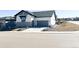 Charming home exterior features a two-car garage and professional landscaping at 5492 Woodroot Pt, Castle Rock, CO 80104
