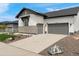 Charming home featuring a stone facade, two-car garage, and well-maintained landscaping at 5492 Woodroot Pt, Castle Rock, CO 80104
