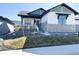 Charming single Gathering house showcasing stone accents, modern design, and meticulously landscaped front yard at 5492 Woodroot Pt, Castle Rock, CO 80104