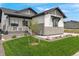 Charming home with manicured lawn, stone accents, and covered porch in a tranquil neighborhood at 5492 Woodroot Pt, Castle Rock, CO 80104