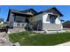 Charming home with a well-maintained lawn, stone accents, and inviting covered porch at 5492 Woodroot Pt, Castle Rock, CO 80104