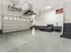 Spacious garage with epoxy flooring, overhead storage racks and stairs to the second floor at 5492 Woodroot Pt, Castle Rock, CO 80104