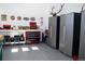 Spacious garage with workbench, tool chests, and storage cabinets at 5492 Woodroot Pt, Castle Rock, CO 80104