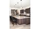Open kitchen featuring an island with granite countertops, stainless steel appliances, and pendant lighting at 5492 Woodroot Pt, Castle Rock, CO 80104