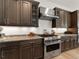 Gourmet kitchen features stainless steel appliances, granite countertops, and ample cabinet space for storage at 5492 Woodroot Pt, Castle Rock, CO 80104