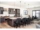Spacious kitchen features stainless steel appliances and a large granite-topped island with barstool seating at 5492 Woodroot Pt, Castle Rock, CO 80104
