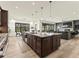 Kitchen with a large island, stainless steel appliances, and an adjacent dining area and living room at 5492 Woodroot Pt, Castle Rock, CO 80104