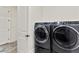 Modern laundry room equipped with high-efficiency washer and dryer units next to the doorway entrance at 5492 Woodroot Pt, Castle Rock, CO 80104