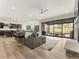 Spacious living room featuring modern furnishings, fireplace, and seamless indoor-outdoor flow at 5492 Woodroot Pt, Castle Rock, CO 80104