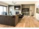 Comfortable living room with a brick fireplace, large TV, and modern decor at 5492 Woodroot Pt, Castle Rock, CO 80104
