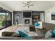 Stylish living room with a stone fireplace, comfortable seating, and inviting decor at 5492 Woodroot Pt, Castle Rock, CO 80104