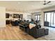 Open living space with a large sectional sofa, island kitchen, and sliding glass doors at 5492 Woodroot Pt, Castle Rock, CO 80104