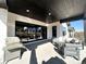 Covered outdoor patio with grill and comfortable seating area with view at 5492 Woodroot Pt, Castle Rock, CO 80104