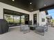 A covered patio with seating area, offering a relaxing outdoor space for entertaining at 5492 Woodroot Pt, Castle Rock, CO 80104
