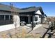 The home's rear exterior shows a cozy covered patio and landscaped yard with easy access through sliding glass doors at 5492 Woodroot Pt, Castle Rock, CO 80104