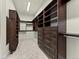 A spacious walk-in closet with custom shelving and drawers for organized storage of wardrobe and accessories at 5492 Woodroot Pt, Castle Rock, CO 80104