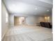 Finished basement featuring plush carpet, a couch, and access to other areas of the home at 26722 E Peakview Pl, Aurora, CO 80016