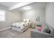 Bright bedroom with carpet, a comfortable bed with a floral comforter, and a gray couch at 26722 E Peakview Pl, Aurora, CO 80016