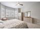 Inviting bedroom with plush carpet, ceiling fan, shuttered windows, and a comfortable sitting area at 26722 E Peakview Pl, Aurora, CO 80016